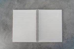 spiral notebook on gray textile