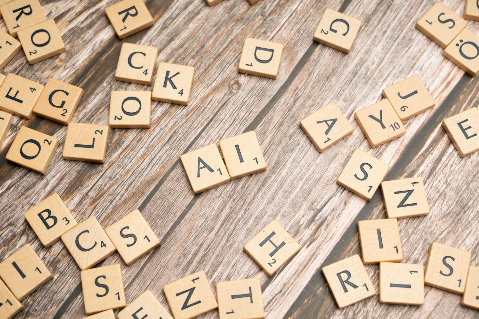 scrabble tiles on a wooden table with the word rock